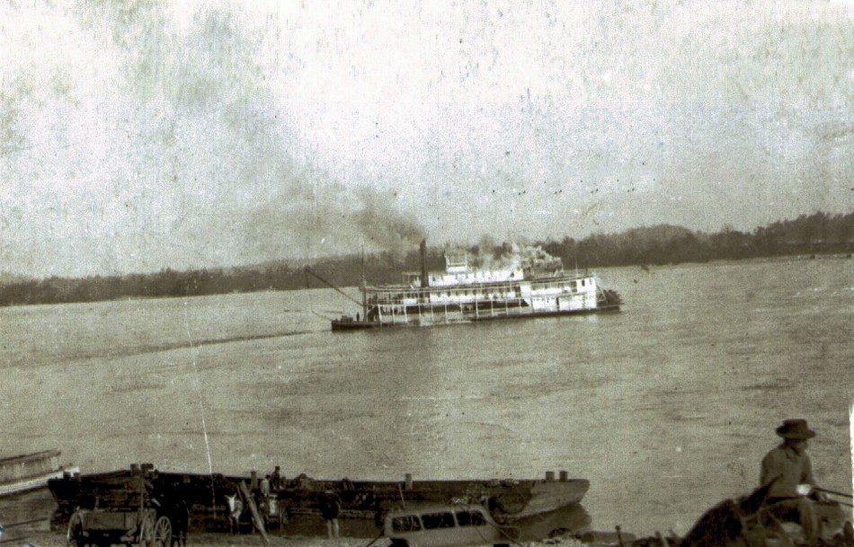 128 Steamboat under way down river & barge docked